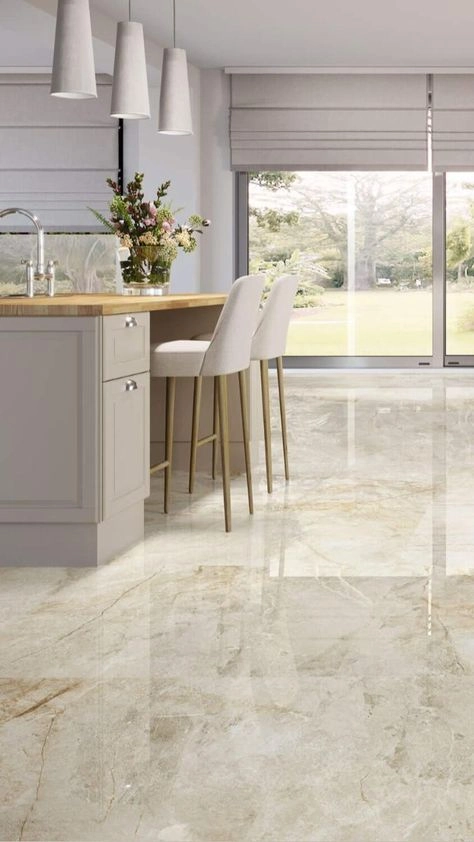 Luxurious polished marble-look floor tiles in a bright modern kitchen with island seating